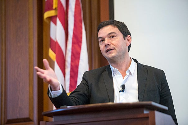 Noted French economist Thomas Piketty spoke before an overflow crowd inside Austin Hall at Harvard Law School, touching on his bestselling book's widely critiqued equation for explaining growing income inequality.
