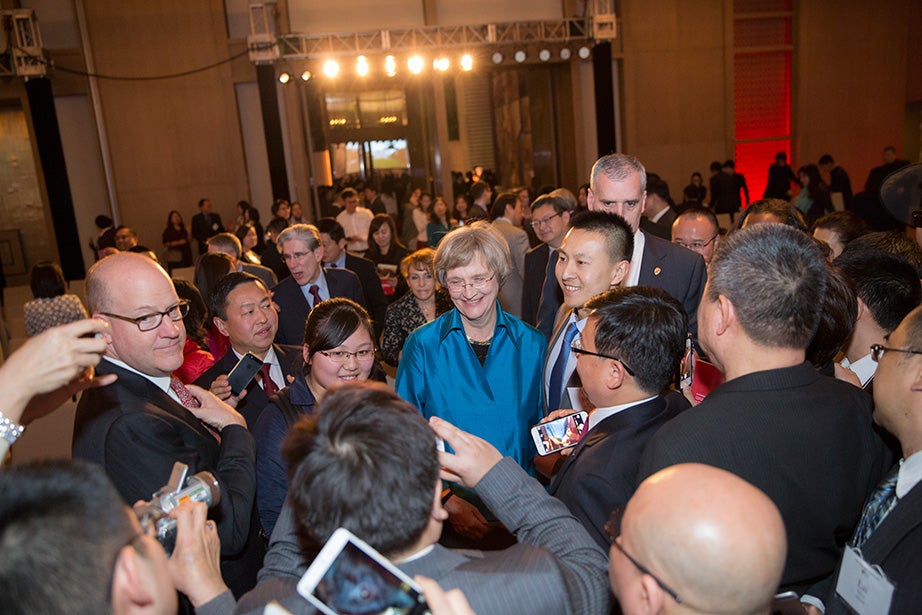 Harvard President Drew Faust is flanked by faculty and friends after speaking at a Your Harvard alumni event in Beijing. 