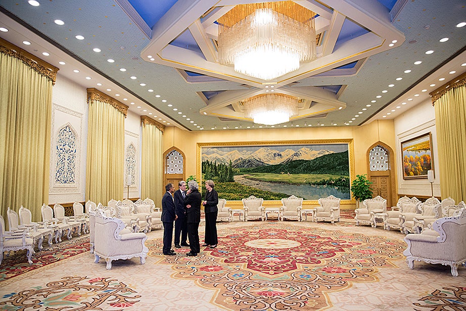 Drew Faust (right) talks with Harvard delegation members Krishna G. Palepu (from left), the Ross Graham Walker Professor of Business Administration; Julio Frenk, dean, Harvard T. H. Chan School of Public Health; and Mohsen Mostafavi, professor of architecture and dean of the Graduate School of Design, before meeting with  Chinese President Xi Jinping.