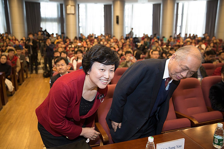 Chen Xu (left), party secretary of Tsinghua University, and William Caspar Graustein Professor of Mathematics and Professor of Physics Shing-Tung Yau listen to the Tsinghua Global Vision Lecture, "Universities and the Challenge of Global Climate Change” at Tsinghua University.