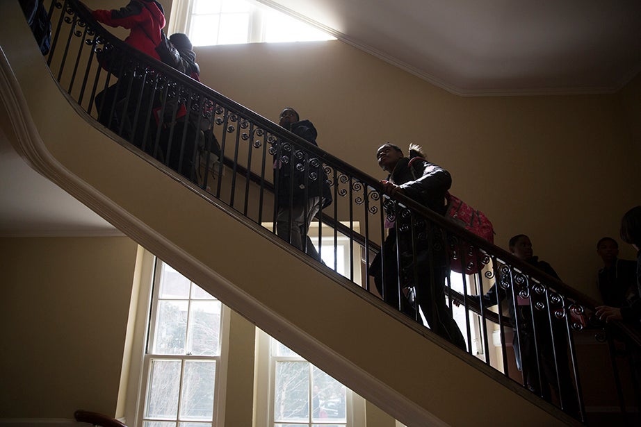 Scholars climb the stairs to Agassiz Theater to hear Harvard College Dean Rakesh Khurana speak. Rose Lincoln/Harvard Staff Photographer
