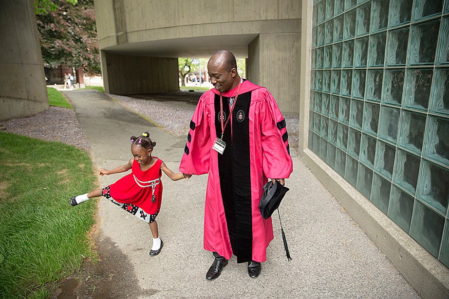 Raphael Arku, S.D. ’15, and his 4-year-old daughter, Souzana, celebrate outside the Carpenter Center during Commencement. Kris Snibbe/Harvard Staff Photographer