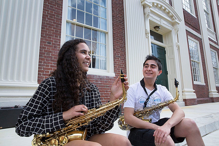 Mariah Goldsmith practices saxophone with volunteer David Armenta.