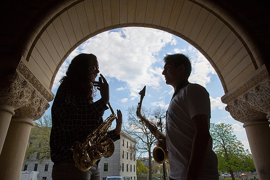 Framed by the arches of Austin Hall at the Harvard Law School, Mariah Goldsmith practices saxophone with volunteer David Armenta. 