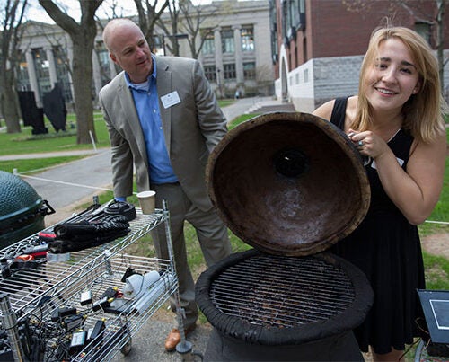After 220 pounds of brisket, 880 man-hours of smoking, and countless more hours of research, design, and construction in Kevin "Kit" Parker's "Engineering Sciences 96" class, the students appear to have pulled off the creation of a better barbecue. Parker (background) joins Jordan DeGraaf '16 during the final leg of the experiment. 