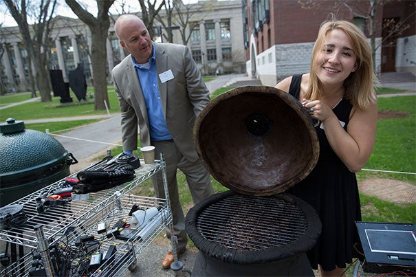 After 220 pounds of brisket, 880 man-hours of smoking, and countless more hours of research, design, and construction in Kevin "Kit" Parker's "Engineering Sciences 96" class, the students appear to have pulled off the creation of a better barbecue. Parker (background) joins Jordan DeGraaf '16 during the final leg of the experiment. 