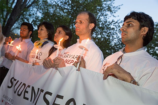 Harvard T.H. Chan School of Public Health doctoral student Elina Pradhan (second from left) was part of a candlelight vigil on the steps of the Memorial Church Thursday. Joining Pradhan, who has family in Kathmandu, were Muhammad Ferdaus (from right) of the Community College Initiative Program sponsored by the U.S. Department of State and Harvard Chan School students Xeno Acharya and Jigyasa Sharma.