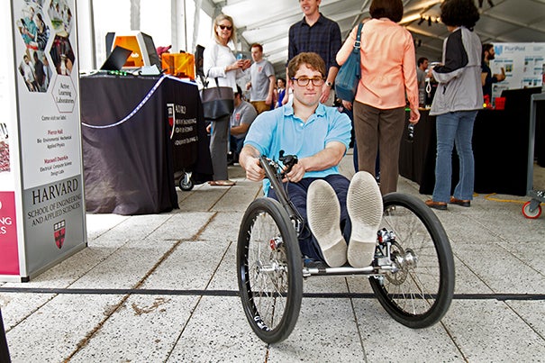 Harvard SEAS students presented projects developed throughout the school year at the SEAS Design and Project Fair. Joe Pappas '17 rode the Crimson Cruiser, a lightweight go-kart designed to run on minimal electrical energy. Photo by Kiera Blessing