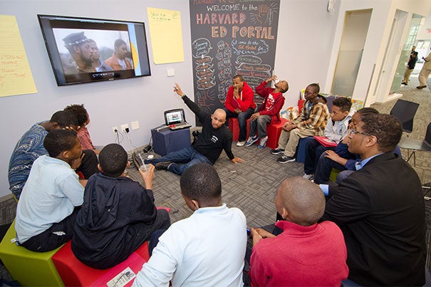 Boston Public Schools teacher Mwalimu Donkor Issa works with young men at the Harvard Ed Portal during the 2015 Dynamic Young Men’s Leadership commencement celebration. The initiative  focuses on empowering young black and Latino men, encouraging them to pursue their dreams, and working closely with teachers and parents to provide students with tools for academic and professional success.