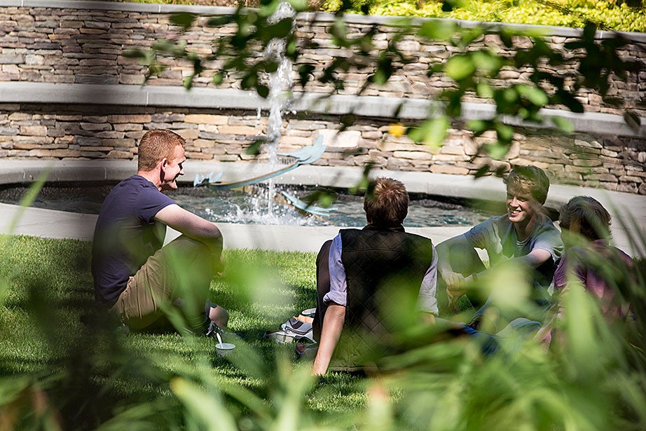 James Graham ’17 (right) takes a break from class to converse with friends Matthew Bennett (left) and Alex and Marcus Rhodes at the Sunken Garden.