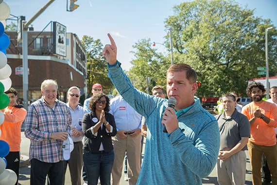 State Representative, Kevin G. Honan (plaid shirt, from left), Ayanna Pressley, (African American) member of the Boston City Council in Boston, look on as Boston Mayor, Martin J. Walsh celebrates the 12th Annual Brian J. Honan 5K Road race in Allston, where members of the Harvard Community helped to raise money to aid and foster local and national programs that support education, recreation, housing and healthcare. On the right next to the mayor State Senator Sal DiDomenico (grey shirt, hands folded). Kris Snibbe/Harvard Staff Photographer at Harvard University.