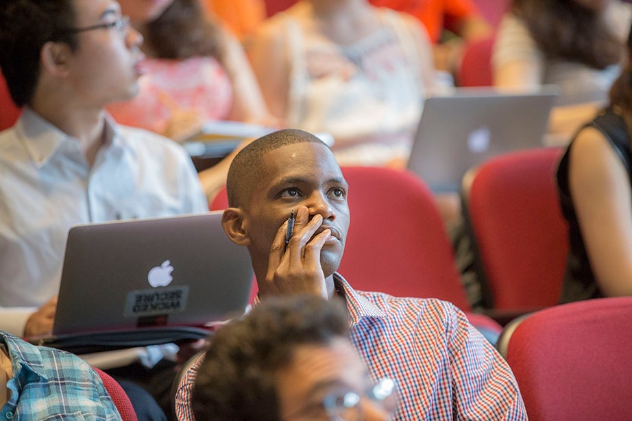 A student ponders Edward Glaeser’s lecture inside Jefferson Hall. Kris Snibbe/Harvard Staff Photographer