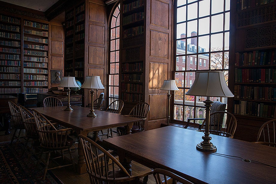 Matching lamps line wooden tables in Dunster’s library.