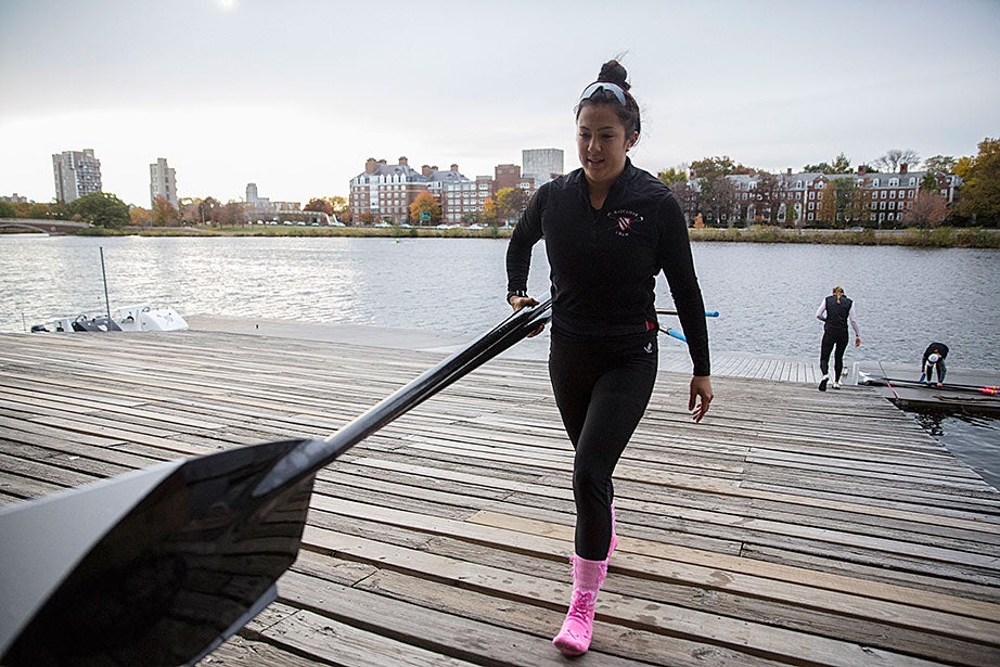Emily Gaudiani '17 carries oars into Weld Boathouse.