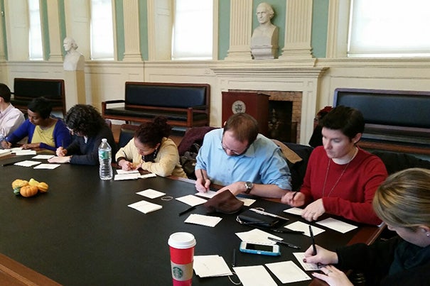 Harvard Faculty of Arts and Sciences staff members gathered in the faculty room at University Hall to see friends, enjoy cider and cookies, and write personal thank-you notes to co-workers.