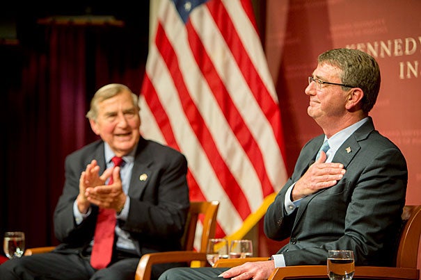 Defense Secretary Ashton Carter (right) returned Tuesday evening to the Harvard Kennedy School, where he was a faculty member from 1984 to early 2011, to talk with Graham Allison, director of the Belfer Center for Science and International Affairs, about the conflict in Syria and to pitch Harvard students on the many public service opportunities available in the military.