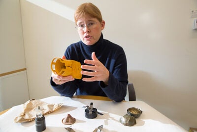 Bonnie Docherty, a senior instructor at Harvard's International Human Rights Clinic, traveled to Geneva to advocate for stronger regulations on incendiary devices, which she calls “exceptionally cruel weapons.” Here she shows inert pieces of cluster munitions, another inhumane weapon, which she helped ban.