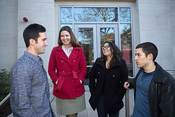 Amanda Kool (red jacket) directs the Community Enterprise Project at Harvard Law School, where students like Matthew Diaz (from left), Carolyn Ruiz, and Steven Salcedo help small business owners, entrepreneurs, and community groups.