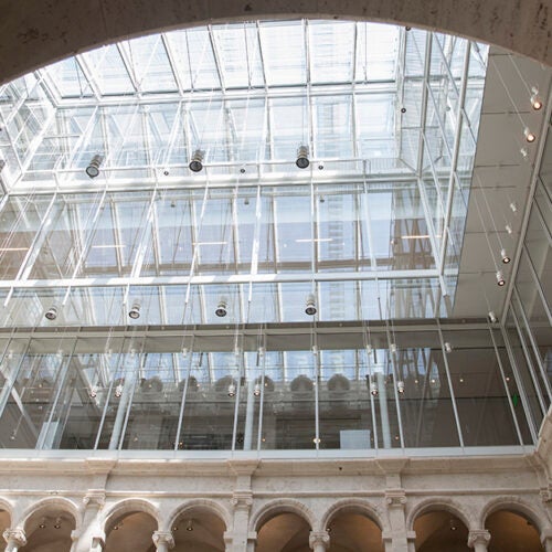 The new glass rooftop that now tops Harvard Art Museums allows natural light to filter down into the courtyard. 
