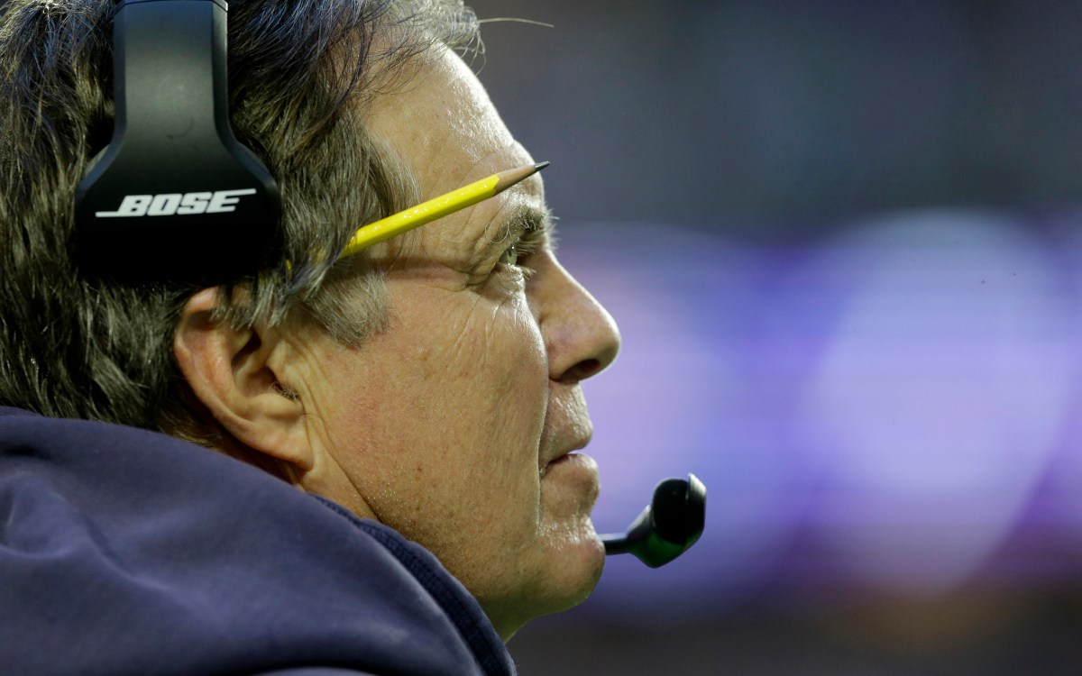Patriots coach Bill Belichick wears headset on the sidelines during the first half of NFL Super Bowl XLIX.