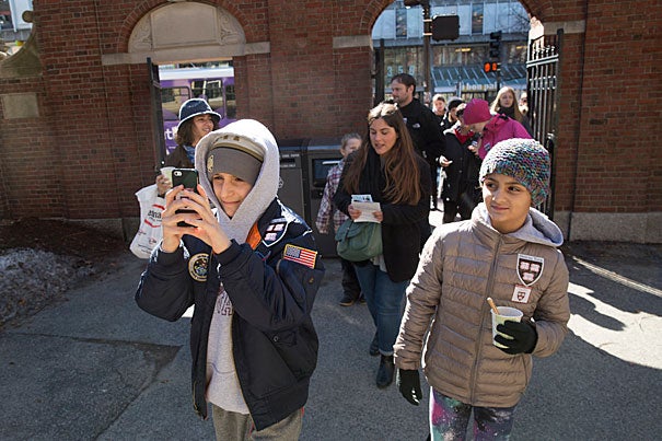 Anthony Mancuso (left), 12, follows Harvard's official interactive online tour app  as his sister, Sophia, 8, looks on. The Mancusos traveled from Westchester County, New York, to scope out Harvard.