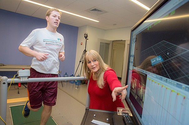 A new study led by Professor of Physical Medicine and Rehabilitation Irene Davis (right) found that a group of runners who had never been hurt landed each footfall more softly than a group who had been injured badly enough to seek medical attention. Pictured on the treadmill is Matthew Ruder, a laboratory engineer at  Spaulding National Running Center.