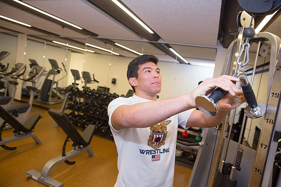Spencer Kiehm ’18, a member of the wrestling team, works out in a Dunster House gym. Kris Snibbe/Harvard Staff Photographer