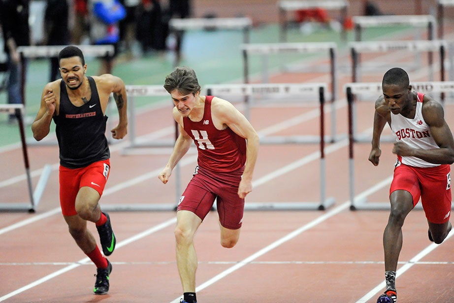 Jay Hebert ’18, center, pulls out a victory in the 60-meter hurdles with a career-best time of 8.12 seconds.