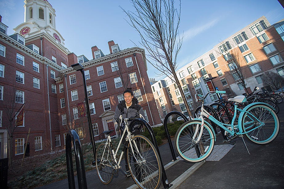 Sally Gee '16 locks up her bike on new bike racks outside of Dunster House. Kris Snibbe/Harvard Staff Photographer