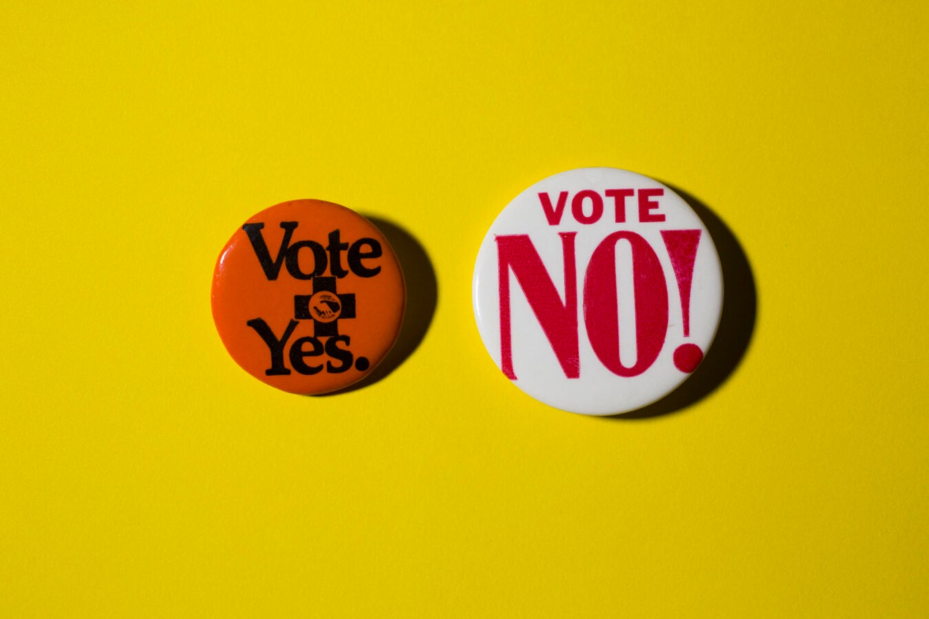 Buttons for and against ballot initiatives.