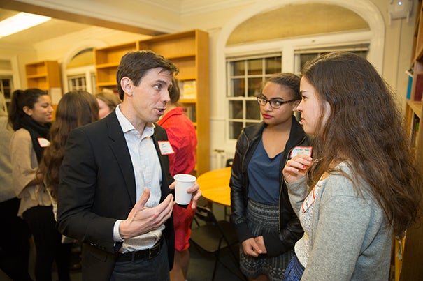 During the student-faculty dinner, David Elmer shared his story with Sabrina Yates '19 (center) and Sarah Angell '18. "I came close to going to Quantico and joining the FBI,” said Elmer, a professor in the Classics Department, recalling a period of uncertainty.  
