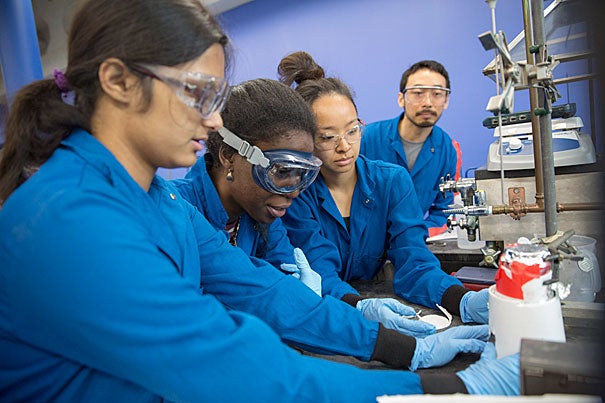 Undergraduates Anumita Das '16 (from left), Similou Akintorin '16, and Terilyn Chen '16 and teaching fellow David Wu test the effectiveness of biodiesel made from used vegetable oil from Annenberg Hall. 
