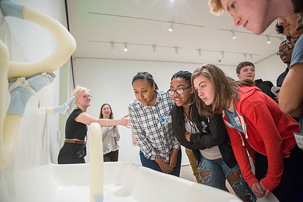 Graduate student teacher Rosie Busiakiewicz (from left, photo 1) engages in a discussion with Beminet Desalegn, Danielle Reeves, Sophie Harrington, and other CRLS students during a visit to the Harvard Art Museums. 