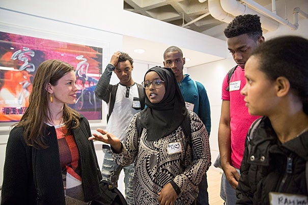 Julia Kemp (left),  associate director of The Arthur Rock Center for Entrepreneurship, said the Harvard event was “all about discovery.” 
Kemp greeted Brighton High School students Hibo Moallim (center) and Rahwa Gidey (far right) at the Harvard Innovation Lab for the New Venture Competition. 