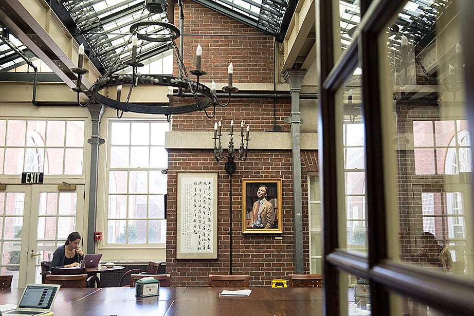 The Adams House dining hall has several adjoining rooms that are also used as dining, socializing, and study spaces. The decor of this room includes a glass ceiling and glass doors that filter in natural light. 