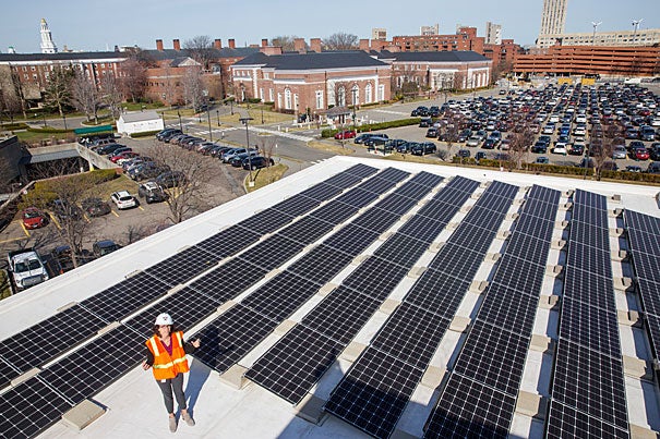 Standing on the roof of Batten Hall, Julia Musso, the energy and sustainability coordinator for Harvard Business School, shows an array of 113kW solar panels that provide energy for the HBS campus. In 2015, HBS also installed solar panels on its Travis Street building and a new solar thermal unit on the roof of Esteves Hall that uses heat from the sun to provide hot water. The University’s Schools and departments have installed more than 1MW of solar panels on rooftops across Harvard’s campus, including at the Harvard Athletics Complex, Canaday Hall in Harvard Yard, the Divinity School, the Graduate School of Education, Harvard Forest, and Arnold Arboretum.