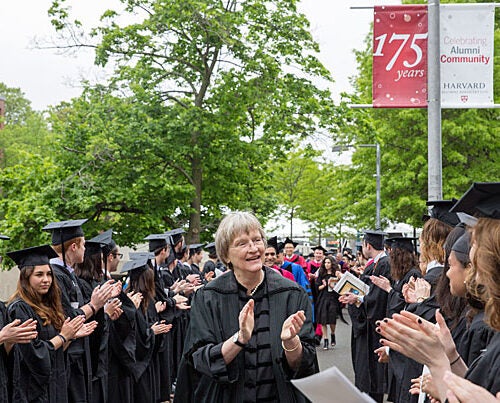 President Drew Faust applauds the seniors processing to the Phi Beta Kappa Literary Exercises. 