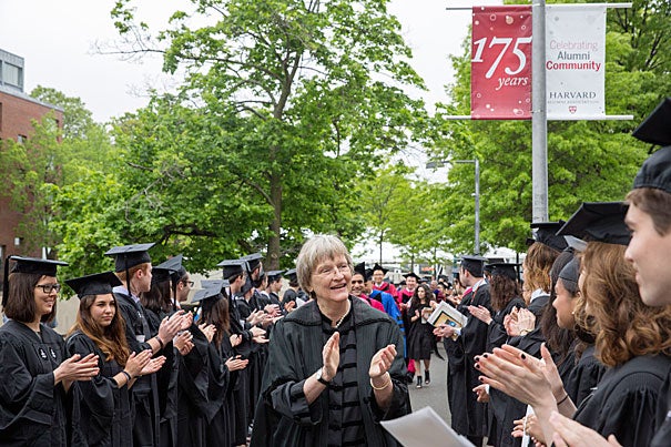 President Drew Faust applauds the seniors processing to the Phi Beta Kappa Literary Exercises. 