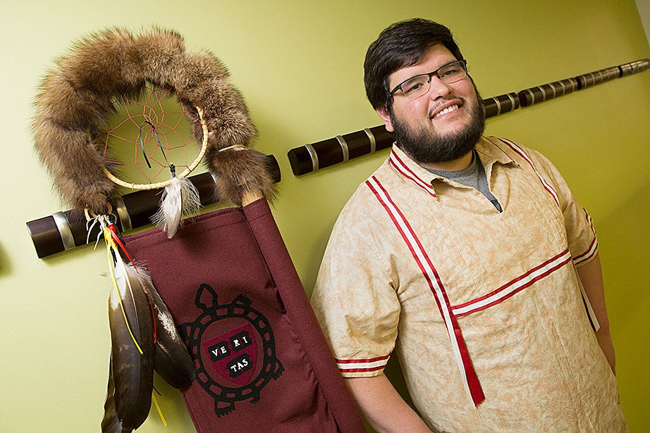 Caden Chase ’17 (Seneca/Cayuga), current co-president of Native Americans at Harvard College, poses with the HUNAP eagle feather staff. Chase recalls going to a Halloween party during his freshman year and encountering a non-Native woman dressed as Pocahontas, who greeted everyone with a raised hand as she said, “How!” “I don’t think she was doing it out of malice, just ignorance,” Chase says, “but thankfully I haven’t seen that again.”
