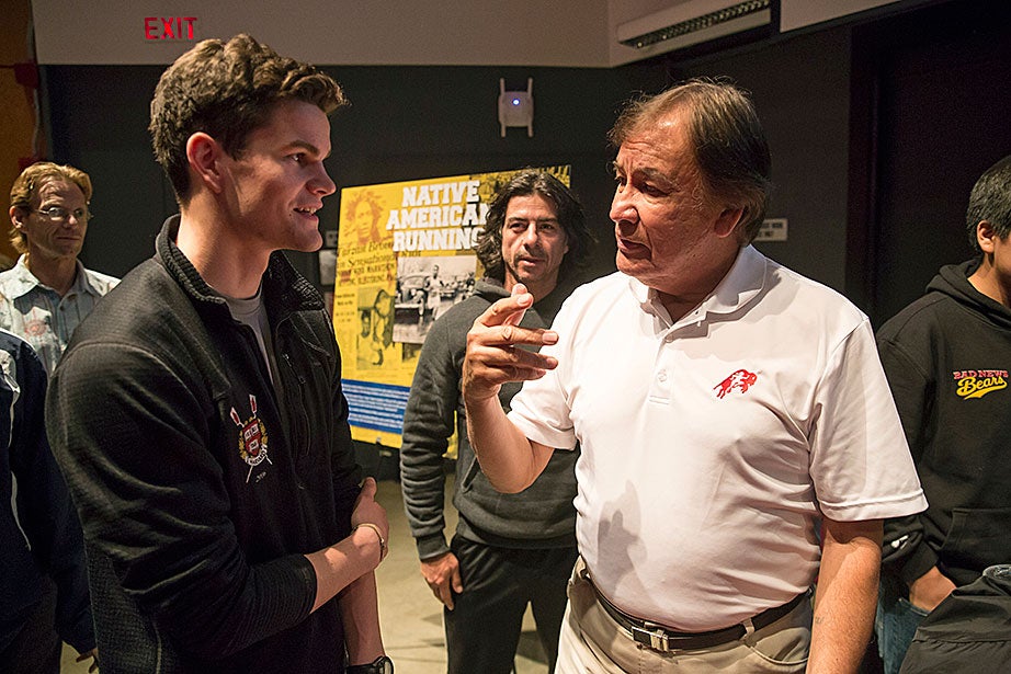 Miles Graham ’16, left, speaks with 1964 Olympic gold medalist Billy Mills (Oglala Lakota). For Mills, running was not an end in itself, but a vehicle for building bridges between people of different cultures and religions. At age 77, Mills is on the road more than 300 days a year with his foundation Running Strong for American Indian Youth, promoting the physical and spiritual benefits of running for indigenous people in the United States and around the world. 