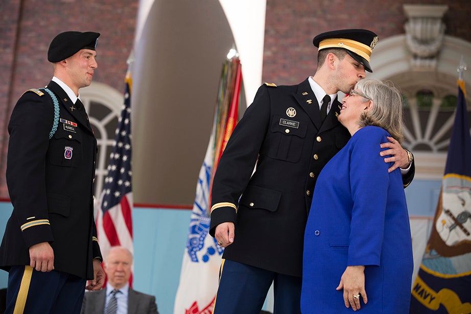 James Clarke (center) is commissioned and pinned by his family at the ROTC commissioning ceremony in Tercentenary Theatre. Stephanie Mitchell/Harvard Staff Photographer