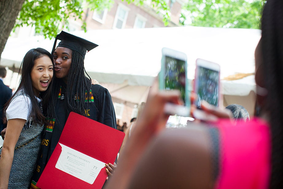 Ivie Tokunboh (right) is photographed with Eunice Kim after receiving her degree at the diploma presentation and luncheon at Winthrop House. Stephanie Mitchell/Harvard Staff Photographer
