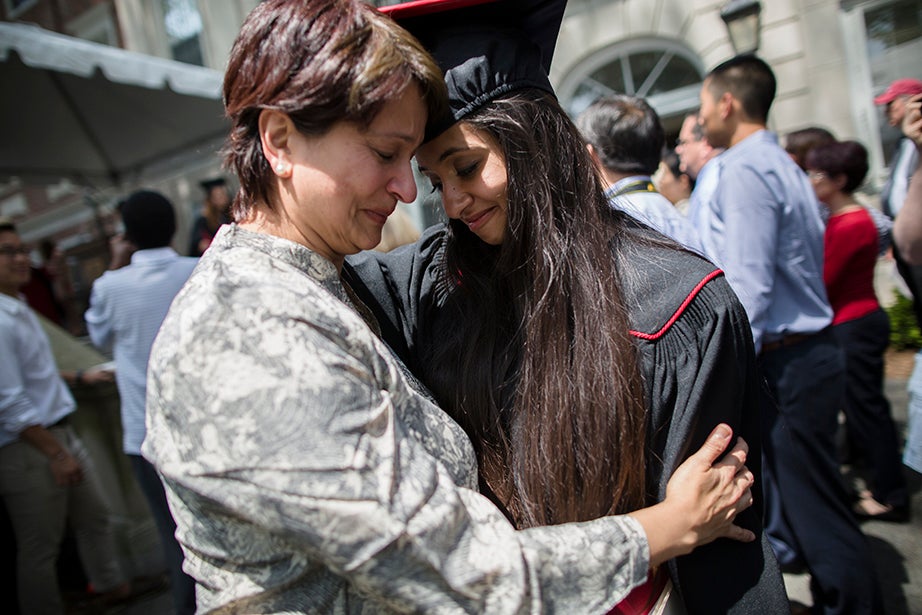 Kirin Gupta (right) shares a moment with her mother, Devika, after she receives her diploma. Stephanie Mitchell/Harvard Staff Photographer