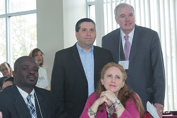 The Legislators' Breakfast brought together Wils Magloire (seated left) and Ann Pellagrini, both of the Jackson Mann Community Center, State Sen. Sal DiDomenico (standing left), and State Rep. Kevin G. Honan.