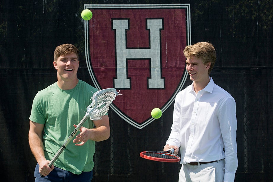Beau (left) and Nicholas Bayh '18 juggle balls with sticks from their respective sports. Beau is on the lacrosse team, while Nick plays for a competitive club tennis team at Harvard. Jon Chase/Harvard Staff Photographer