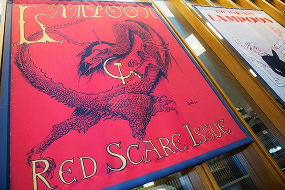 The cover of the “Red Scare Issue” from 1950—featuring a red dragon with a hammer and sickle stuck in its claws—is just one of many Lampoon-related treasures on display through October 2. Kris Snibbe/Harvard Staff Photographer
