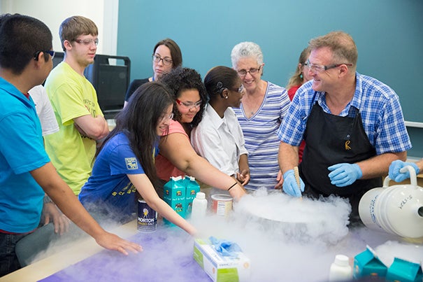 Horace Mann students Walberto Hernandez (from left), Christopher Ancheta, Liu Xiao Ting, Kaysha Hernandez, and Janasia Butler feel the cold vapors sublimating from Daniel Rosenberg's bowl of ice cream base as he freezes it with liquid nitrogen.