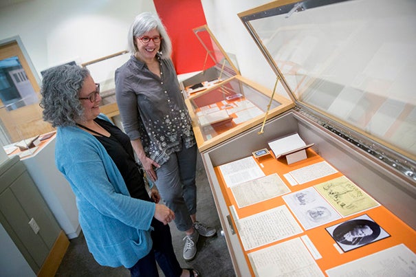 Jennifer Weintraub (left), digital archivist/librarian, and Jane Kamensky, Schlesinger Library director, view a selection of items from the Blackwell collection before they are installed in the new exhibit.