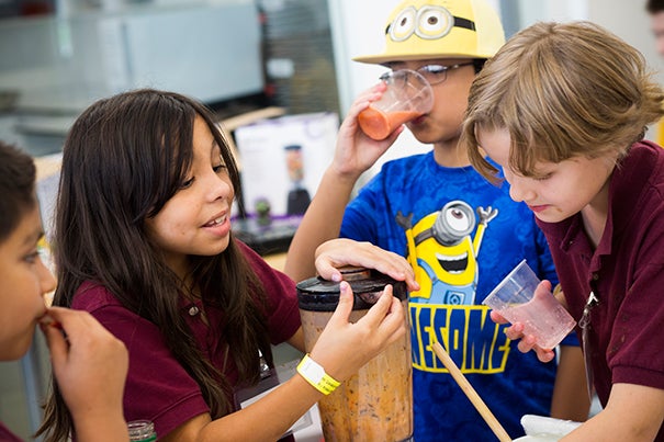 It wasn’t all chemistry and chocolate at the “Science and Cooking for Kids” program as Luis Agulion (from left), Emily Nacimento, Anson Chau, and Emily Carrigan added fruit smoothies to the mix. Stephanie Mitchell/Harvard Staff Photographer
