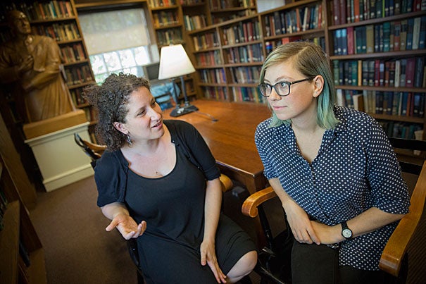Inside the Dudley House library, Vanessa Zoltan, M.Div. '15 (left), proctor and member of the Board of Freshman Advisers, and Ariana Nedelman, M.Div. candidate '18, HDS staff member, discuss their new podcast "Harry Potter and the Sacred Text," which looks at the famous books as instructive and inspirational texts. 